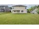 Expansive backyard and exterior view of the two-story home with a covered patio at 8826 Lakecrest Way, Union City, GA 30291