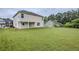 Spacious backyard with lush lawn and views of the home's rear exterior, offering privacy at 8826 Lakecrest Way, Union City, GA 30291