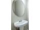 Close-up of pedestal sink with elegant mirror, offering a stylish and functional space at 8826 Lakecrest Way, Union City, GA 30291