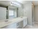 Bathroom featuring dual sinks, large mirror with vanity lighting, and cabinets for storage at 8826 Lakecrest Way, Union City, GA 30291