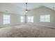 Large bedroom with a vaulted ceiling, fan, and ample natural light from the multiple windows at 8826 Lakecrest Way, Union City, GA 30291