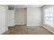 Empty bedroom with natural light from a window and a closet door at 8826 Lakecrest Way, Union City, GA 30291