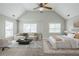 Nicely staged bedroom with a ceiling fan, a couch, a bed, and natural light from multiple windows at 8826 Lakecrest Way, Union City, GA 30291