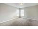 Bright bedroom featuring neutral walls, carpet flooring, and double windows offering natural light at 8826 Lakecrest Way, Union City, GA 30291