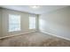Bedroom with natural light from two windows and neutral wall-to-wall carpeting at 8826 Lakecrest Way, Union City, GA 30291
