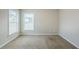Well-lit bedroom with neutral walls, carpet flooring, and double windows offering neighborhood views at 8826 Lakecrest Way, Union City, GA 30291