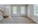 Inviting living room with a neutral color palette and abundant natural light from the front-facing windows at 8826 Lakecrest Way, Union City, GA 30291