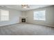 Spacious living room features a fireplace, large windows, and neutral paint, creating a cozy atmosphere at 8826 Lakecrest Way, Union City, GA 30291