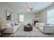 Inviting living room featuring modern furnishings, stylish decor, a fireplace, and plenty of natural light at 8826 Lakecrest Way, Union City, GA 30291