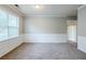 Neutral paint enhances a versatile living space with chair rail molding and large windows for natural light at 8826 Lakecrest Way, Union City, GA 30291