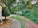 Enjoy this peaceful backyard with lush greenery, a stone walkway, and an inviting, serene environment at 119 Michelle Dr, Mcdonough, GA 30252