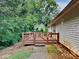 Wood deck perfect for outdoor relaxation, with an adjacent yard area surrounded by mature trees at 119 Michelle Dr, Mcdonough, GA 30252