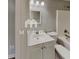 Well-lit bathroom featuring a single sink vanity, modern fixtures and a large mirror at 119 Michelle Dr, Mcdonough, GA 30252