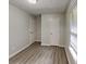 Bedroom featuring new laminate flooring, a large window, and a double door closet with white doors at 119 Michelle Dr, Mcdonough, GA 30252