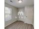 Neutral bedroom features vinyl floors, a window for natural light, and closet space at 119 Michelle Dr, Mcdonough, GA 30252