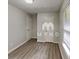 Bright bedroom featuring wood-look floors, neutral walls, and bright natural light through the window at 119 Michelle Dr, Mcdonough, GA 30252