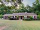 Charming single-story brick home with a well-manicured lawn and mature landscaping providing curb appeal at 119 Michelle Dr, Mcdonough, GA 30252