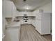 Bright kitchen featuring white cabinets, granite countertops, stainless appliances and new laminate flooring at 119 Michelle Dr, Mcdonough, GA 30252