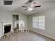 Cozy living room featuring a fireplace, ceiling fan and modern flooring and light-filled window at 119 Michelle Dr, Mcdonough, GA 30252