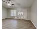 Bright living room featuring modern flooring, a ceiling fan and a window letting in lots of natural light at 119 Michelle Dr, Mcdonough, GA 30252