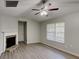 Cozy living room featuring laminate flooring, stone fireplace, large window, and a ceiling fan at 119 Michelle Dr, Mcdonough, GA 30252