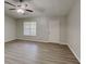 Bright living room with new laminate flooring, a ceiling fan, and a window to let in natural light at 119 Michelle Dr, Mcdonough, GA 30252