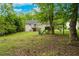 Backyard with plenty of lush trees, grassy area, a deck, and a playset at 236 Fairview Dr, Dallas, GA 30157
