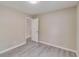 Bedroom featuring neutral walls, wood-look floors, closet access and a modern ceiling light at 236 Fairview Dr, Dallas, GA 30157