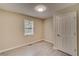 This is a bedroom with light-colored walls, a light fixture, wood-look floors, and a window at 236 Fairview Dr, Dallas, GA 30157