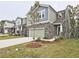 Attractive home showcasing a stone front, a two-car garage, and a manicured lawn in a lovely neighborhood at 3305 Morgan Rd, Buford, GA 30519