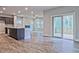Open-concept kitchen and living area with modern finishes, stainless steel appliances, and sliding glass doors to deck at 3305 Morgan Rd, Buford, GA 30519