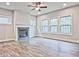 Bright living room featuring a cozy fireplace, hardwood floors, recessed lighting, and large windows at 3305 Morgan Rd, Buford, GA 30519