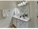 Bright bathroom with white cabinetry, sleek marble countertop, and large framed mirror at 4610 Point Rock Dr, Buford, GA 30519