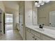 Bathroom vanity with white countertop and tiled flooring leading to a carpeted bedroom space at 4610 Point Rock Dr, Buford, GA 30519