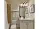 Traditional bathroom with tile surround, vanity, framed art, mirror, and new toilet at 4610 Point Rock Dr, Buford, GA 30519