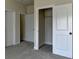 Bedroom with plush neutral carpeting, closet and bathroom entrances at 4610 Point Rock Dr, Buford, GA 30519