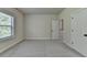 Bedroom with neutral carpet, white trim, a double door closet, and bright window at 4610 Point Rock Dr, Buford, GA 30519