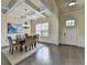 Bright dining room features modern lighting, coffered ceilings, gray wood flooring, and wainscoting at 4610 Point Rock Dr, Buford, GA 30519