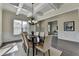 Dining room features coffered ceiling, chair rail molding, hardwood floors and neutral color palette at 4610 Point Rock Dr, Buford, GA 30519