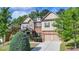 Charming home with mixed brick and siding, complemented by a well-maintained lawn and mature trees at 4610 Point Rock Dr, Buford, GA 30519