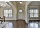 Elegant foyer with dark hardwood floors, white trim, paneled walls, and abundant natural light at 4610 Point Rock Dr, Buford, GA 30519