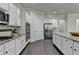 Open kitchen featuring white cabinets, stainless steel appliances, speckled granite countertops, and an island at 4610 Point Rock Dr, Buford, GA 30519
