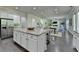 Kitchen island featuring a speckled granite countertop with seating and an open floor plan at 4610 Point Rock Dr, Buford, GA 30519
