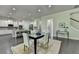 Open concept: dining area flows seamlessly to a white kitchen with a large island at 4610 Point Rock Dr, Buford, GA 30519