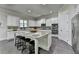 Open floor plan kitchen with a speckled granite countertop island at 4610 Point Rock Dr, Buford, GA 30519