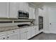 Bright kitchen with white cabinets, stainless steel appliances and speckled granite countertops at 4610 Point Rock Dr, Buford, GA 30519