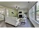 Sun-filled living area with fireplace, large windows, hardwood floors, and comfortable white sofa at 4610 Point Rock Dr, Buford, GA 30519