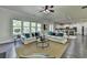 Open floor plan with living area and kitchen, hardwood floors, neutral tones, and ample seating at 4610 Point Rock Dr, Buford, GA 30519