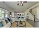 Spacious living room with white sofas and a large window, steps away from a white kitchen at 4610 Point Rock Dr, Buford, GA 30519