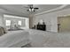 Expansive main bedroom with sitting area features tray ceilings, carpet floors, and a doorway to the hallway at 4610 Point Rock Dr, Buford, GA 30519